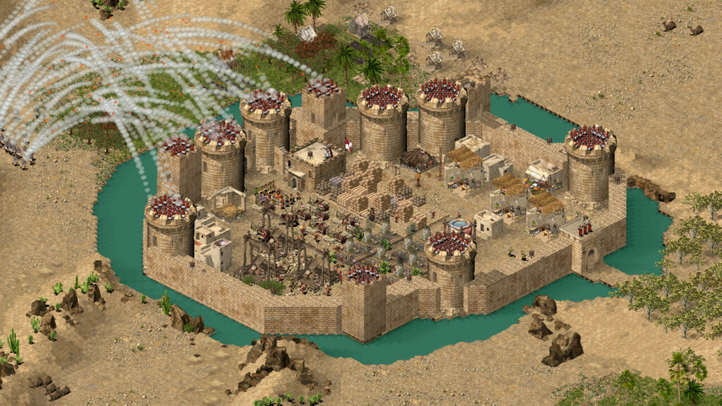 Stronghold Crusader screenshot of catapults firing at fortress